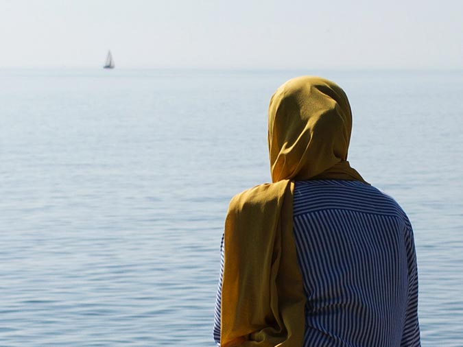 Muslim Woman Gazing at Ocean